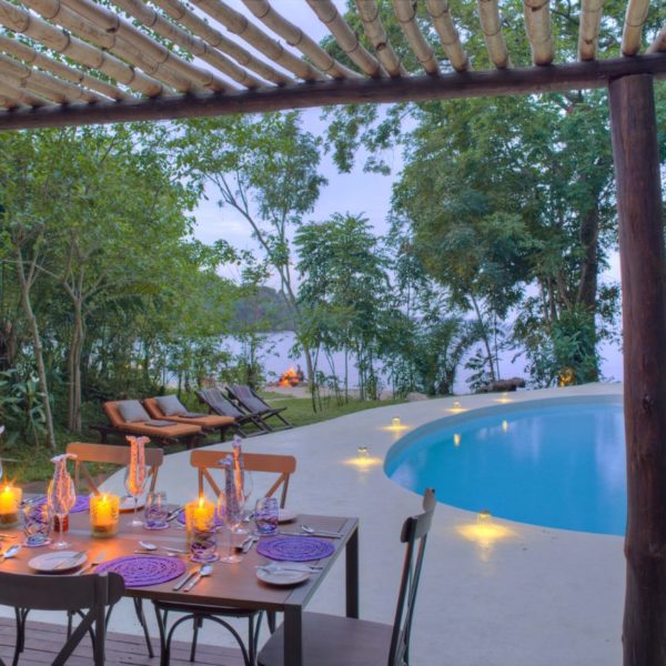 Rubondo Island - Private dining set up around the pool, overlooking Lake Victoria