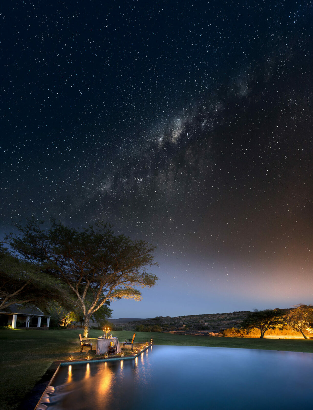 Image of the starry skies at Bushmans Kloof in the Cederberg in South Africa. An intimate candlelit dinner is set up alongside the pool for added romance. | TrueAfrica Safaris | Blog | Cape Town Diva