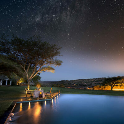 Image of the starry skies at Bushmans Kloof in the Cederberg in South Africa. An intimate candlelit dinner is set up alongside the pool for added romance. | TrueAfrica Safaris | Blog | Cape Town Diva