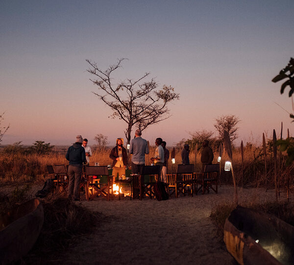 Asilia-Africa--Usangu-Expedition-Camp_Guests-gather-around-the-campfire-at-night