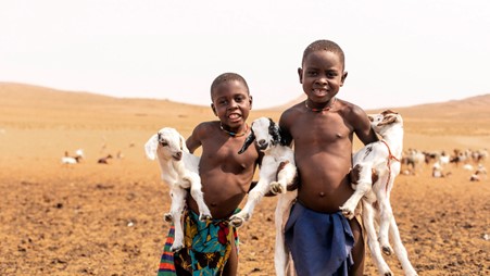 local Himba children holding goats