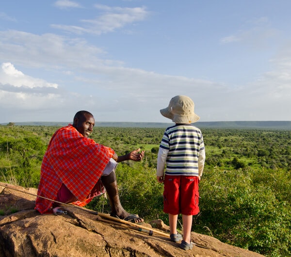 hoto of Laikipia Wilderness Camp in Northern Kenya showing a Maasai with a young child