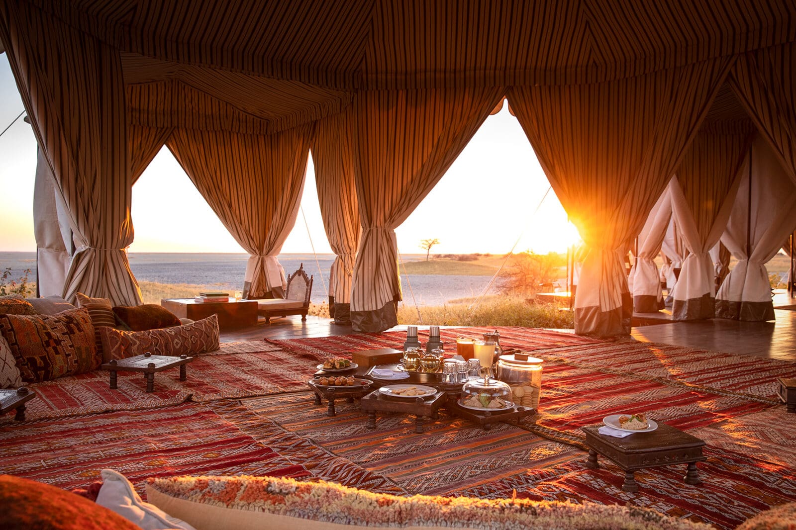 luxurious tea tent at san camp overlooking salt pans at sunset